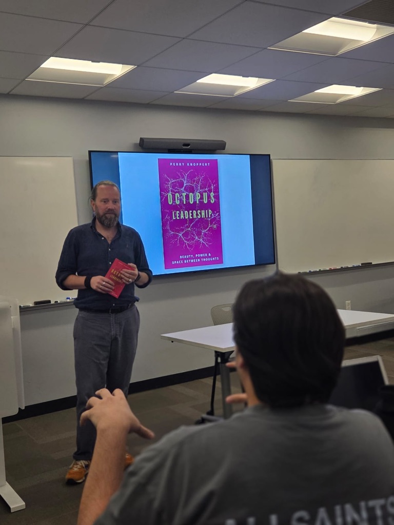 Perry guest lecturing at NYU with the Octopus Leadership book on screen