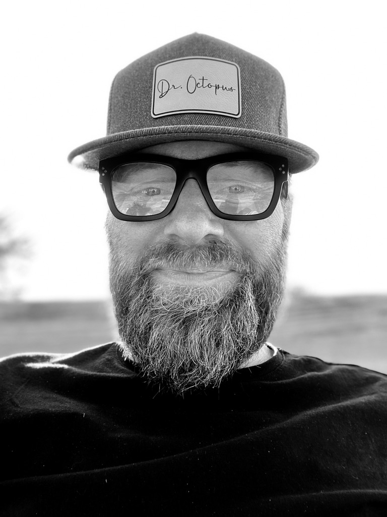 Perry wearing a Dr. Octopus cap and dark glasses