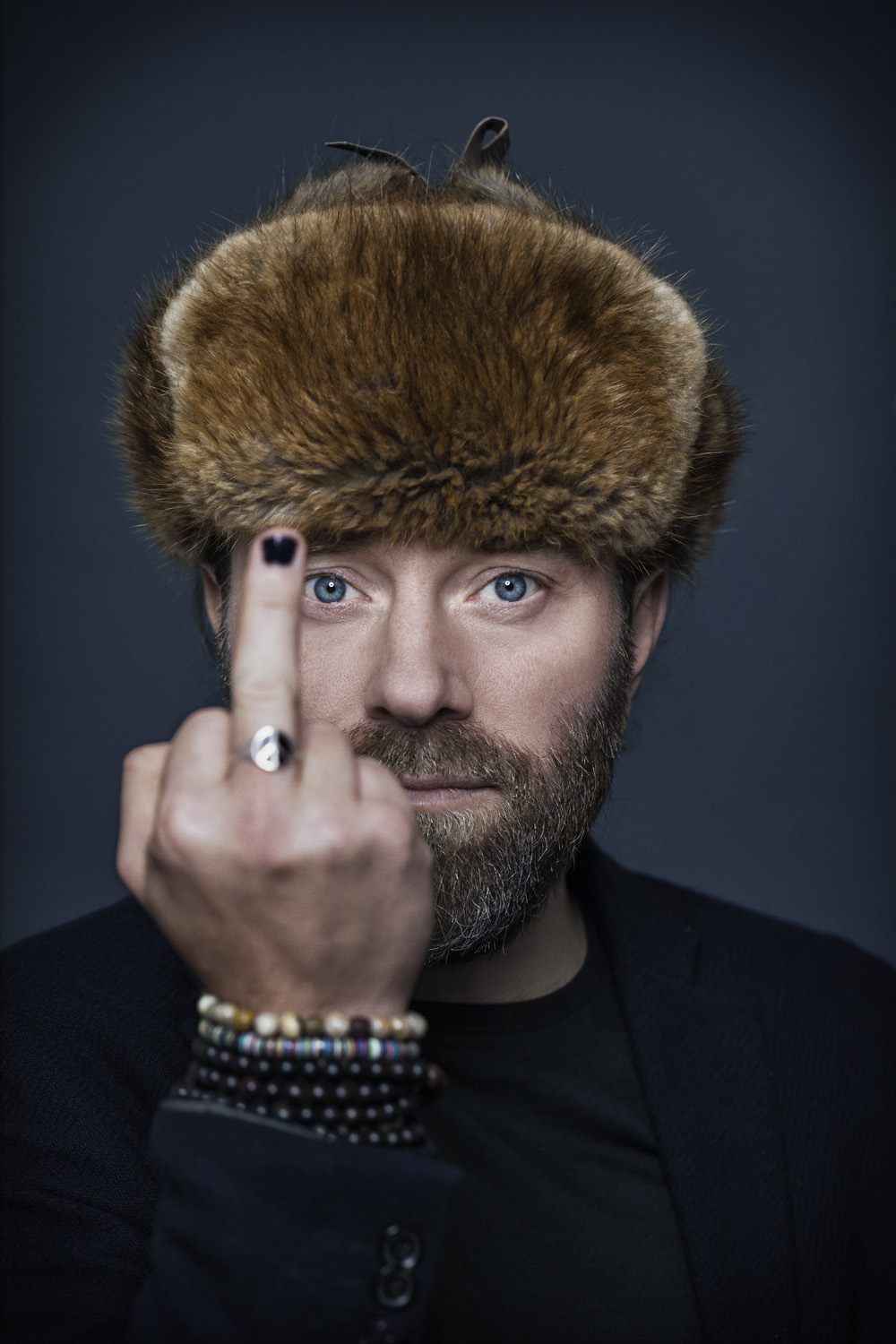 Perry with fur hat raising middle finger