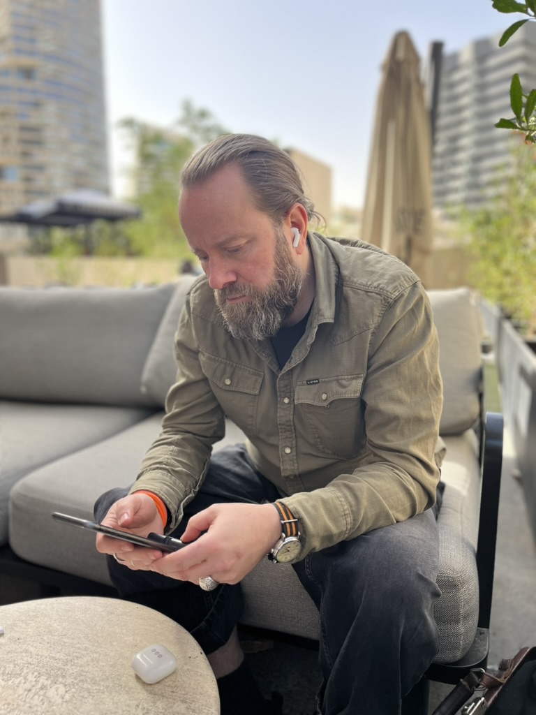 Perry on a rooftop terrace in Riyadh, phone in hand